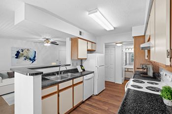 A kitchen with white appliances and wooden cabinets